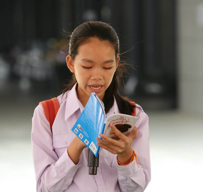 Student reading on mic